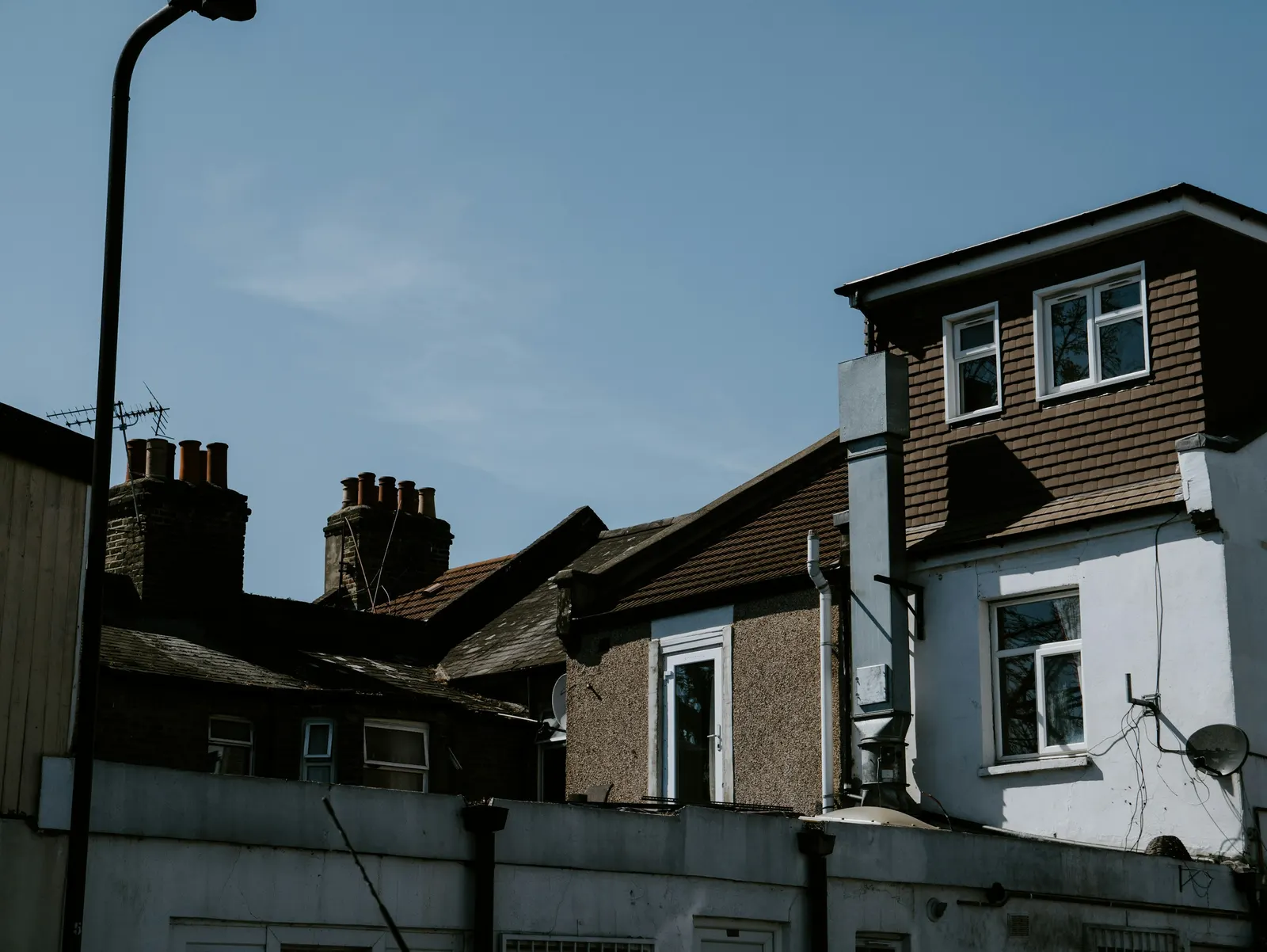 Box dormer loft conversion on the back of a London terrace, seen from the next street