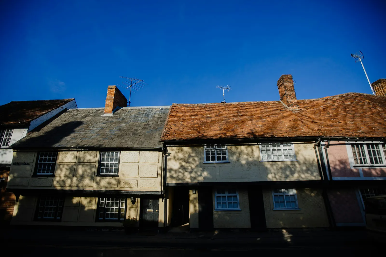 Timber-framed cottages with pargeted plaster on an Essex market town street