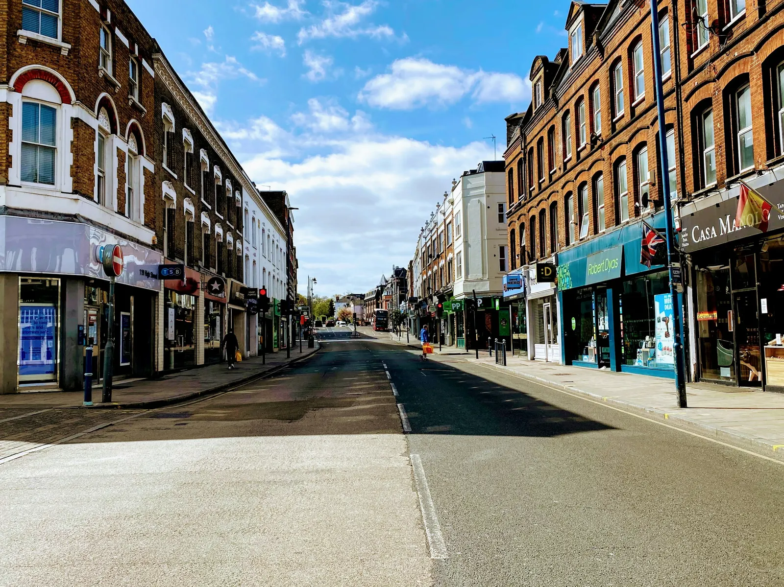 London high street lined with Victorian shopfront parades and flats above