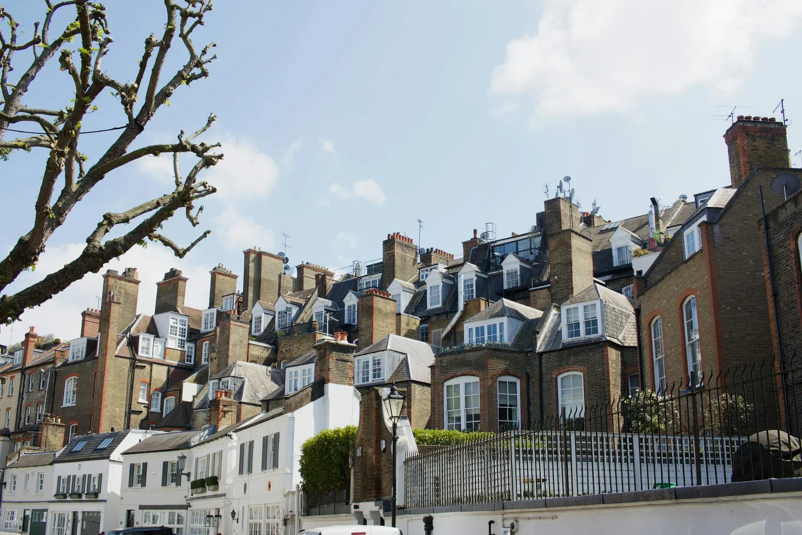 London roofscape of mansard dormers and chimney stacks, the kind of street pattern a feasibility study reads before testing a roof or loft idea