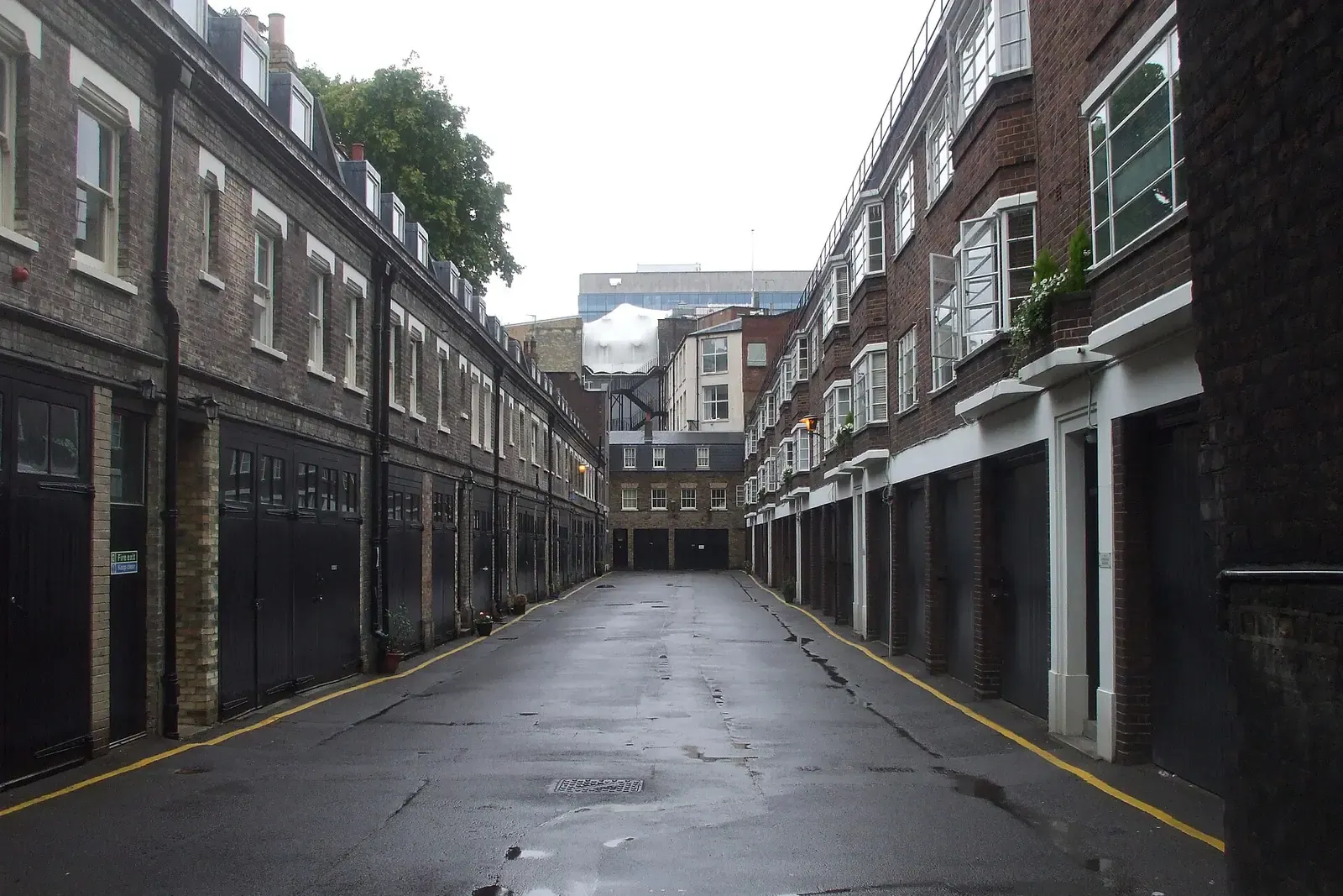 Gower Mews in central London, a narrow road between brick mews buildings with garage doors on the ground floor