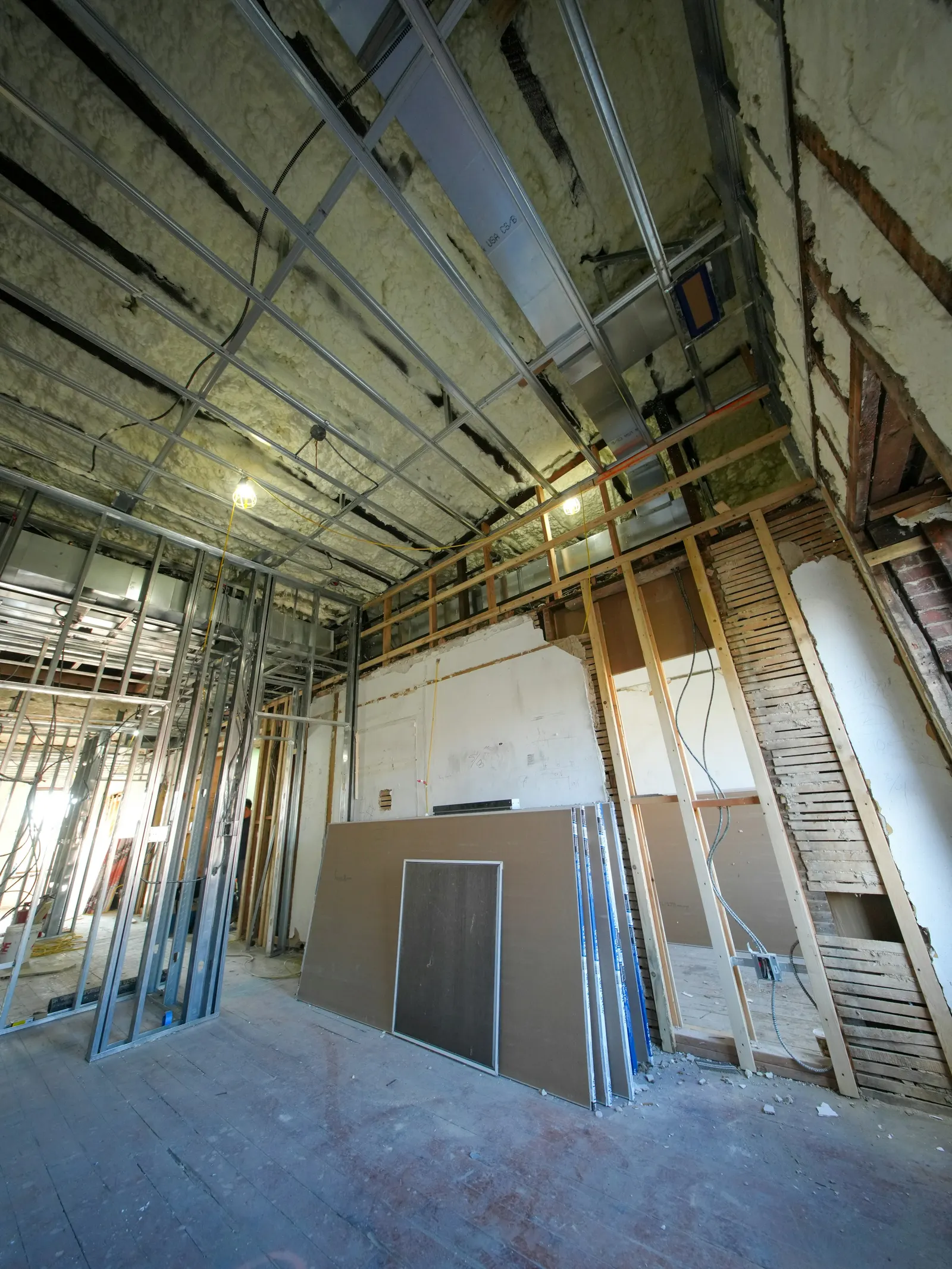 Metal stud partitions and plasterboard sheets during a conversion