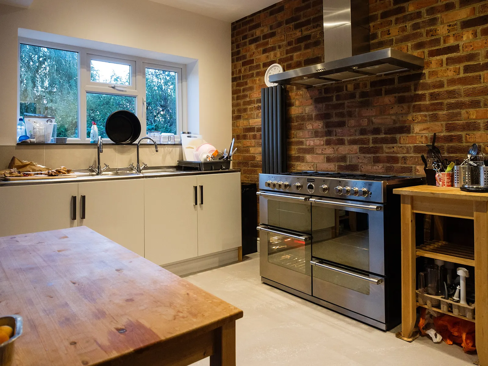 Finished kitchen extension with a long worktop and large glazed doors, the kind of space a 3D image lets you judge before it is built